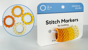 A package of Allstitch Studio stitch markers for knitting, shown with a circular inset displaying four flower-shaped stitch markers in orange, yellow, and cream on a white background.